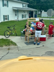 Tucker Shabram of O'Neil buying lemonade from the neighborhood on way to game